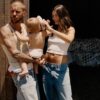 Justin Bieber carrying his son and his wife hailey bieber standing next to him rubbing their son's head